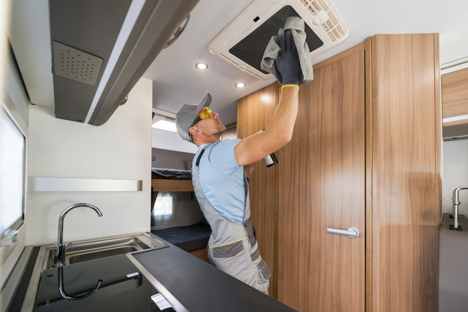 Man checking RV air conditioning system
