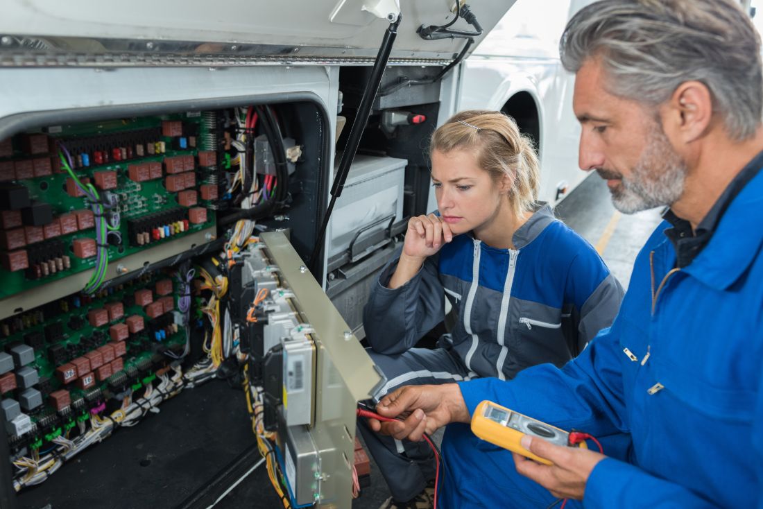 RV mechanics reviewing electrical reparis
